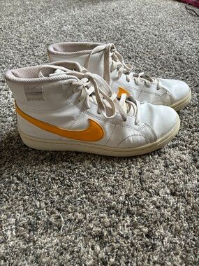 Nike White High-Top Sneakers with Orange Swoosh